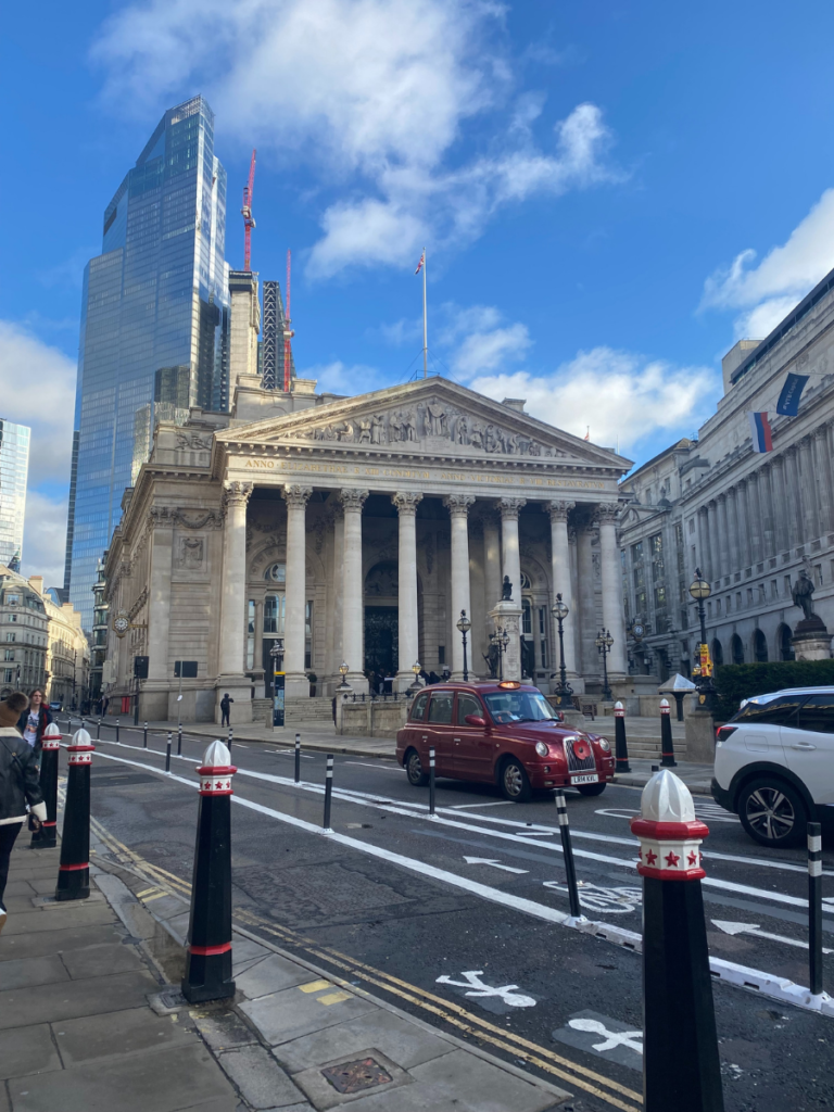 royal exchange building against a bright blue london sky
