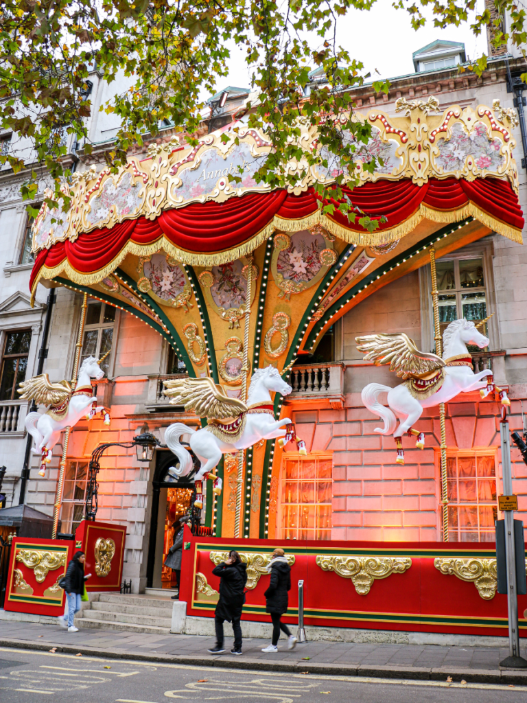 Annabel's Mayfair decorated to look like a Christmas carousel with 3 unicorns decorated in gold and red