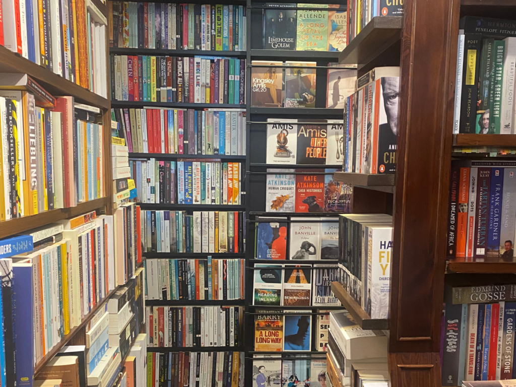 A corner of John Sandoe's shelves stacked high with books