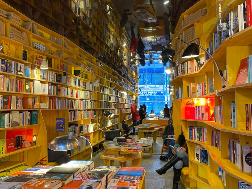 the bright yellow shelves stacked with books are the perfect place to switch off from the digital world