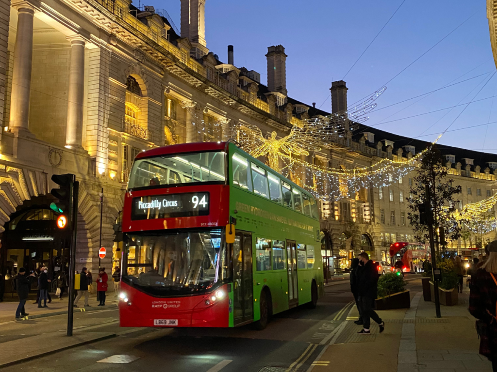 Red London routemaster bus under the Regent Street Christmas lights