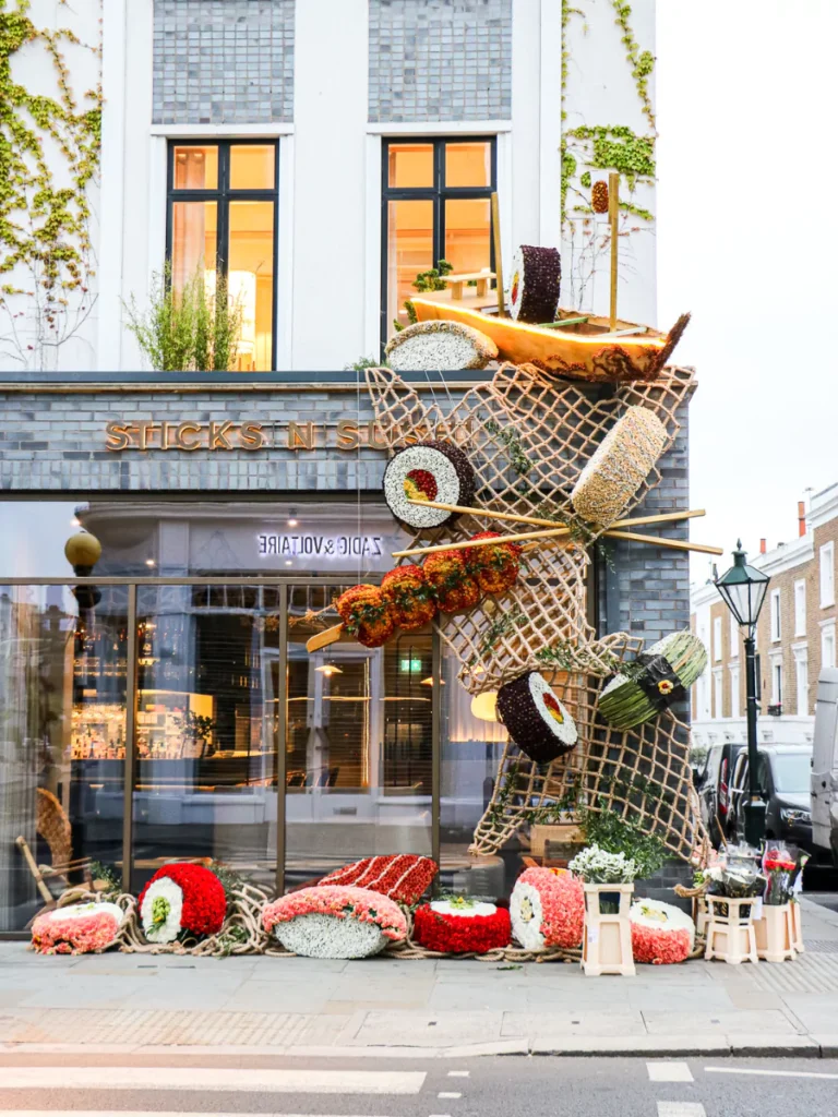 Large sushi crafted from flowers cascade down the outside of Sticks'n'Sushi's Chelsea facade