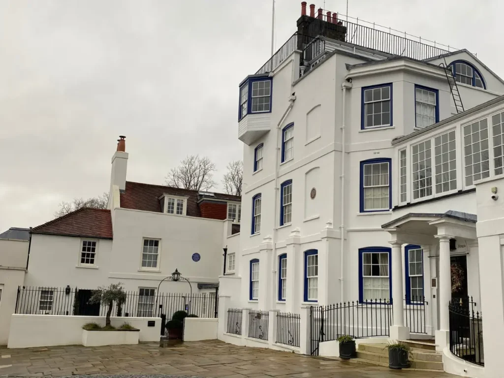 A large white house against a white cloudy sky