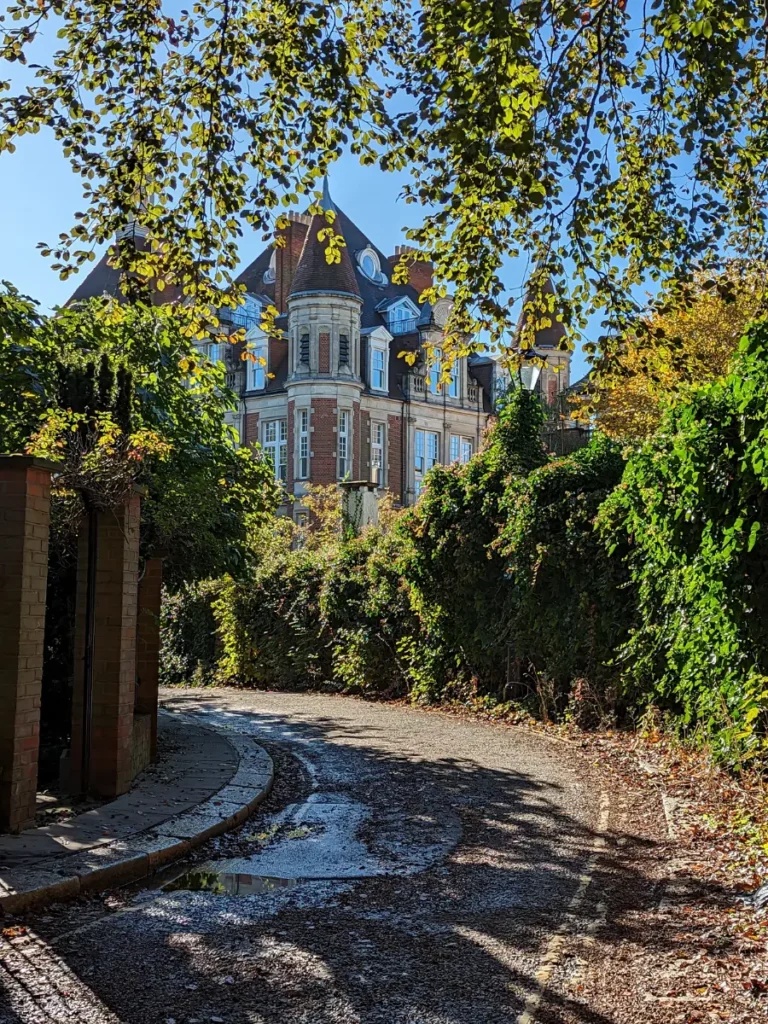 A leafy road in Hampstead looking at a large house