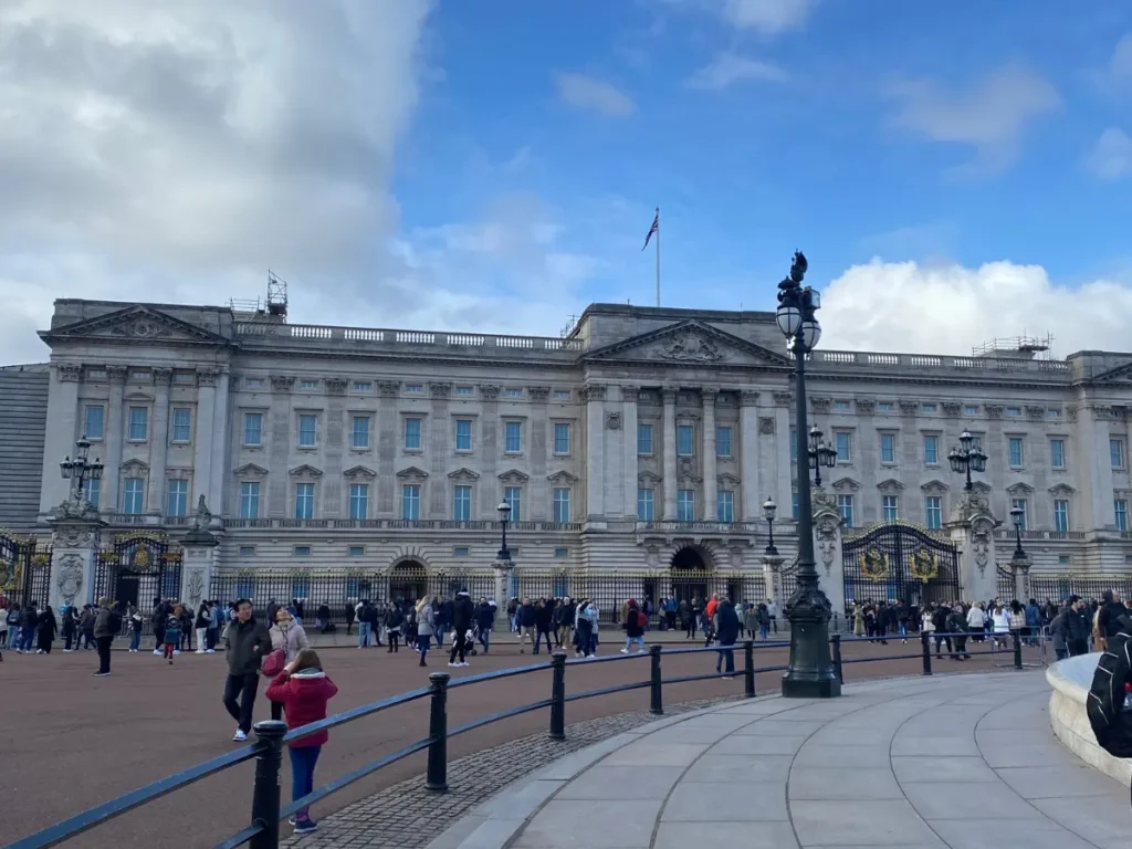 Buckingham Palace against a blue sky with a dappling of white clouds